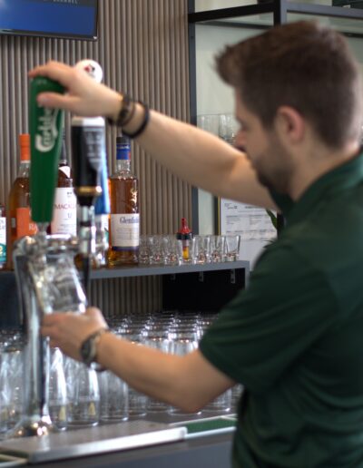 Pete pouring beer blurry