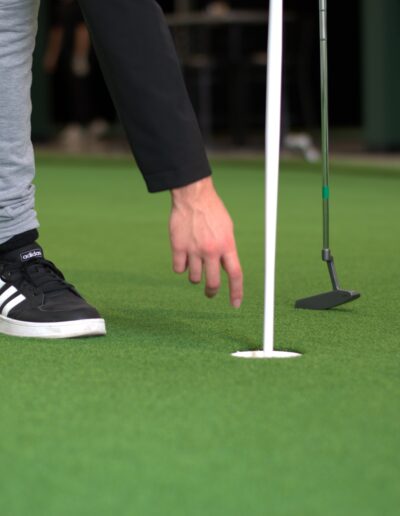 Reaching for ball on green